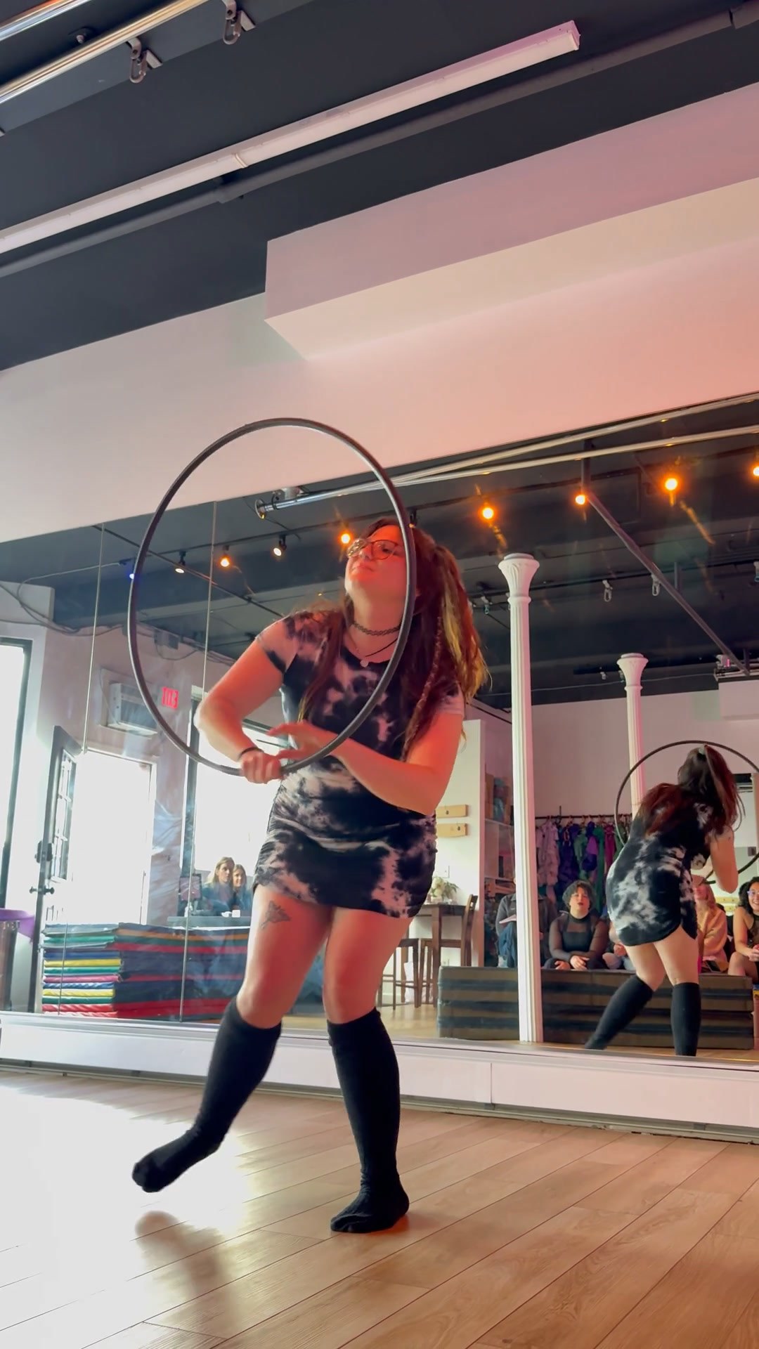 Hula hoop dance — on-body waist work and off-body spins with instructor Lauren. Instructor Lauren dancing with a spinning hula hoop during a circus flow arts class in Chester, NY